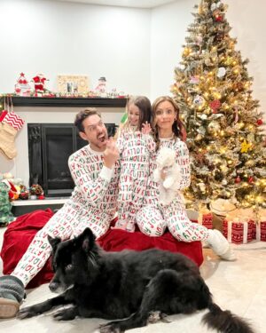 Michelle West Instagram - “Merry Christmas Eve Eve” IYKYK 😆 With a hectic few weeks, we didn’t manage to get the pics I envisioned yet but these put a smile on my face and we had fun while capturing them! Bernie on the other hand, over it 😂

#matchingpajamas #familyfirst #christmaspajamas #positiveinfluencer #teamwest #familymatching