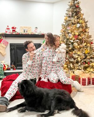 Michelle West Instagram - “Merry Christmas Eve Eve” IYKYK 😆 With a hectic few weeks, we didn’t manage to get the pics I envisioned yet but these put a smile on my face and we had fun while capturing them! Bernie on the other hand, over it 😂

#matchingpajamas #familyfirst #christmaspajamas #positiveinfluencer #teamwest #familymatching