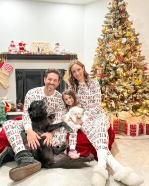 Michelle West Instagram - “Merry Christmas Eve Eve” IYKYK 😆 With a hectic few weeks, we didn’t manage to get the pics I envisioned yet but these put a smile on my face and we had fun while capturing them! Bernie on the other hand, over it 😂

#matchingpajamas #familyfirst #christmaspajamas #positiveinfluencer #teamwest #familymatching