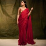 Nayana Elza Instagram - A red saree is a statement of inherent grace 🌹 . . . 📸 @jibinartist @plan.b.actions Saree @larobedesignerboutique Styling @merlin_lizbet MUA @ajayanmakeupartist @sibin_hair_stylist . . . . . , . . . . #saree #red #ootd #flauntinginsaree #nayanaelza #style #fashion #instadaily #instafashion