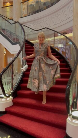 Nicki Chapman Instagram - Best bib & tucker 👗👠👛 ✨

Thanks for all those wonderful messages. It seems you don’t mind me being away & want to see more of life on the high seas 🌊🚢

Evening dress from @marksandspencer 
Shoes & bag @zara 
Earrings @carouseljewels 

Extra points for not looking at my feet too much whilst walking & talking down stairs… 

On each leg of the QM2 voyage they have a gala night. Sometimes 2 & it seems that nearly everyone decides to go glam! Walking around the ship & seeing the guests in all their finery makes me think of years gone by when this was the norm. Glorious (back to normal smart attire/civies every other night). If you don’t fancy dressing up, no pressure at all. This ship is stunning, over 1,130ft in length, it’s also one of the longest at sea & features a deep draught for a smooth and comfortable ride (I cut & paste that bit). This crossing from Tenerife to Namibia has been super smooth ☺️🙏👍

Photo 1 posing
Photo 2 with bestie/the gorgeous @the_noellemason wearing @memories_and_moonbeams (preloved)
Photo 3 breathing in & posing (mark II) 

@cunardline 
Queen Mary 2
#guestspeaker