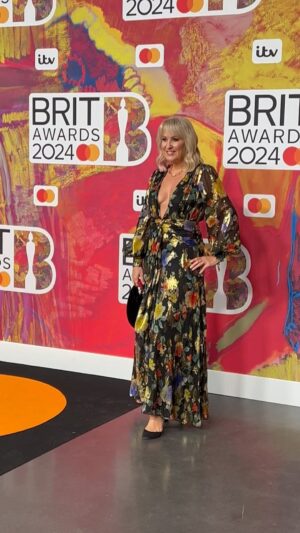 Nicki Chapman Instagram - About last night ✨

Top top night @thebrits with @aritanderson. All glammed & ready for an evening celebrating the best of the best ⭐️

Huge thanks to Tony & the team @warnermusicuk for the best seats in the house & the most brilliant company. Knock out performances from Raye (just the six Brit awards… wow!!) Dua Lipa, Jungle, Rema, Calvin Harris & Ellie Goulding … I would say Kylie but sadly Sensible Cinders had to bail as working on Sunday morning so missed our fave ‘Global Icon!’🫢 Danced until my feet hurt, sang until my throat (& Arit’s ears) hurt & laughed all night. Froze as it was freeezing outside but no complaints from me! (Well just a bit) 

Today is trainers & tracky day 😉

Dress of dreams @rixo 
Shoes @jimmychoo 
Bag @ysl preloved from @maryschiswick 
Glam @wonderlandhairandmakeup & applier of modesty tape! It worked! 
Curls @hairbyninanikol