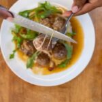 Nyesha Arrington Instagram – I LOOOOVE a comfort meal moment..
and you guys know I am a big fan of soup & stews..

SoooO.. in this recipe, I use the inspiration of French onion soup 🥣
Capturing its soul hugging capability 🤗 

Starts by caramelizing onions, then
deglaze with sherry wine, added in beef stock and cooked down to a beautiful, rich gravy.. 

ALSO- I had ground beef in the freezer so made some meatballs… but even more ALLLSO- had some string cheese, so stuffed the meatballs with cheeeez

Japanese sweet potato mash rounds out this meal of comfort… and I absolutely love food like this because it’s relatively inexpensive & pretty simple to make if you have patience to fill the meatballs individually.

Ground beef was $12 [16oz]
Stock was homemade [so basically free]
1 onion $.65 
Homegrown thyme 
1 bay leaf 
Couple tablespoons of sherry wine 
[and I tossed the cheese in a little cornstarch before filling the meatballs] 
A few sticks of string cheese $.40ea

Cooked the stuffed meatballs in the broiler, in the French onion soup base, which took like 6 mins roughly.

I got about 16 meatballs out of the pound of meat

Finished with a little parm, arugula & blk pepper