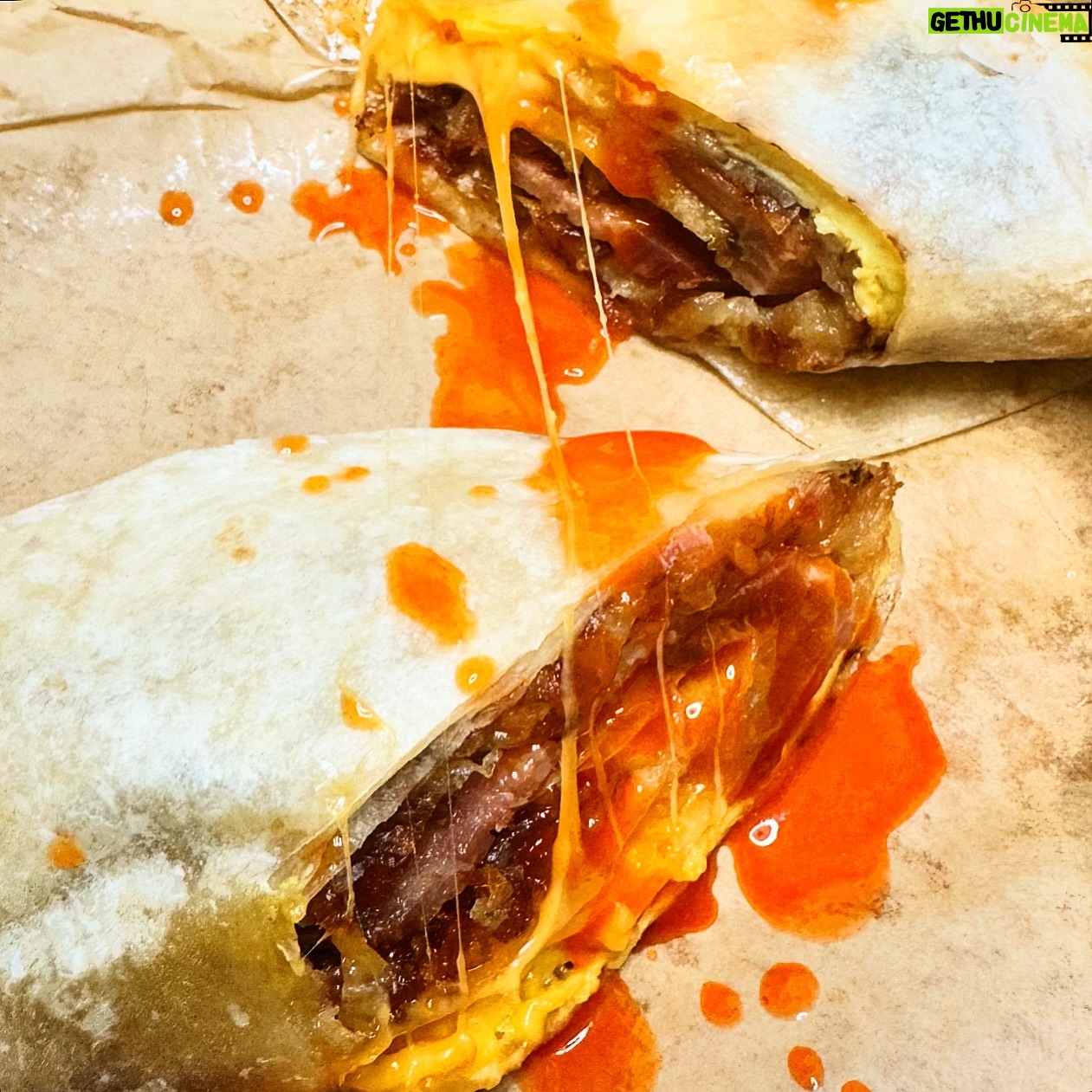 Nyesha Arrington Instagram - Simple things can be great... it's all about execution and sometimes an uncomplicated breakfast burrito is all you need 🌯 Thiccc bacon, potato rosti, egg cooked open faced-omelette style, cheddar cheese, whole green onion confit in the bacon fat while bacon was roasting in the oven and Crystal hot sauce 🌶️ Notes: I think cooking the hashbrowns aswell as the eggs in a circle allows you to get a perfect bite every time ... when you roll the burrito, it makes a spiral of ingredients 🌀- not huge and over filled, where one bite could be all egg the next all beans or what ever other ingredients are in the burrito.. ya know what I mean? On the side: Crushed avocado and a whole charred Serrano chile YES #fridayfoodfeels #breakfastburrito #lifestyle