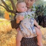 Olesya Rulin Instagram - Golden hour with my little dove. Thank you @artipoppe for making baby wearing comfortable and easy. * the @artipoppe is the only carrier that’s worked for us and one I 100% guarantee is worth the investment. It’s brilliant. . . . Dress and boots are @christydawn