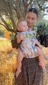 Olesya Rulin Instagram - Golden hour with my little dove. Thank you @artipoppe for making baby wearing comfortable and easy. * the @artipoppe is the only carrier that’s worked for us and one I 100% guarantee is worth the investment. It’s brilliant. . . . Dress and boots are @christydawn