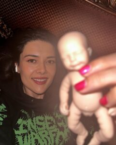 Patti Harrison Instagram - If given the chance i think id be a good mom because id hold the baby like this. And when people in public would yell at me for holding it this way, id say “im so sorry. This better?” Then I’d hold it the right way …and everyone would smile 😊 (P.S- she is awake in these photos! I had her close her eyes for the flash 😌)