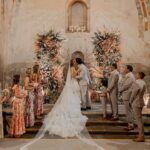 Perry Mattfeld Instagram - Actress @perrymattfeld and @NFL 🏈 player-turned-analyst @mark_sanchez were set up by their mutual friend @scotty_mcknight. "Scotty is one of Mark’s closest childhood friends and ended up officiating our wedding, as he was in fact, the very beginning of our story," Perry explains. After getting engaged in Anguilla, the couple set their sights on @hotelesquintareal and @casa2lagos in Oaxaca, 🇲🇽, for their summer ceremony. "Mark and I fell in love with Oaxaca, and it felt very special to us because we are both hispanic," Perry shares. "I was inspired by the city and its history, its color, architecture, and its sophistication." “@karen.sabag for @karensabagofficial created my one-of-a-kind, custom, dream wedding dress, and I couldn’t be happier with how it turned out,” the bride shares. 🤍 It was the first dress Perry tried on, and she fell in love with the A-line corset design with intricately beaded French lace. The skirt of the dress was more playful with alternating tiers of pleated silk tulle and French beaded solstiss lace. "I wanted something unique, timeless, ornate. . .and Karen created something better and more special than I could have ever imagined.” 📷: @diegopadillaweddings Planning: @verovivaseventos Stationery: @every.little.something @kellykristindesign Beauty: @makeupartisthannah Catering: @restaurante.catedral @pasteleria_carmelita 🎶: @lesliepowellmusic @sethcookmusic Venues: @hotelesquintareal @casa2lagos #perrymattfeld #marksanchez #mexicowedding #destinationwedding #wedding #weddinginspiration