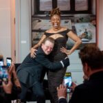 Phoebe Robinson Instagram - When I was asked to interview my friend/mentor Bono at a private book party (hosted by @Bloombergdotorg) celebrating his NYT memoir “Surrender,” I thot to myself, “In my book club, we all getting half chubs,” hence me serving body-ody-ody in a Hershey’s chocolate bar 🍫 wrapping. Jokes aside, this was legit one of the best days of my life. ⠀ Like thirteen year old me would’ve geeked over the opportunity and also fluffed out her Civil Rights era banyang. Seriously, when I was younger I looked I could’ve been in what was originally the Little Rock Ten, but alas I missed it all because I overslept the night before, so Nine it was! ANYWAY! The point is sometimes you dream of and hope for and manifest certain things, but the universe has a way of surprising you with even more when you surrender to it. ⠀ To kiki with a person whose music and philanthropy has meant so much to my life was a dream come true. To hear the way he speaks of and writes about Ali, his wife of 40 years moved me to tears. The way his band mates - Edge, Adam, & Larry - have bettered him in ways that he’s long known and ways he’s still discovering is touching without being overly sentimental. And to watch him take his passions seriously in one breath and then also take the piss out of himself the next is a masterclass in authenticity. He’s a thoroughly self-possessed person, which is probably the most beautiful thing about him. ⠀ So thanks, B, for the pleasure of your friendship, the gift of your generosity, and welcoming me deeper into the @red family by having me join the Advisory Board (I know B said Creative Council, but it’s the Advisory Board). I can’t wait to get to work and help the debilitating presence HIV/AIDS still has in this world. You, (RED), and so much more continue to make this the ride of a lifetime. So I’mma buckle up and keep dressing like some dude’s future second wife that he’s about to meet. 😂😏🤷🏾‍♀️. #FBF ⠀ Hair: @lurissaingridhair Makeup: @fatimotisadare Styling: Moi Dress: @alexperryofficial Shoes: #BottegaVeneta Earrings: @cloverpost