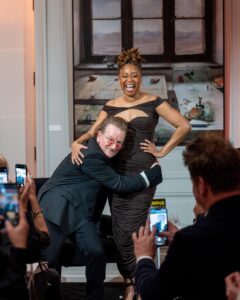 Phoebe Robinson Instagram - When I was asked to interview my friend/mentor Bono at a private book party (hosted by @Bloombergdotorg) celebrating his NYT memoir “Surrender,” I thot to myself, “In my book club, we all getting half chubs,” hence me serving body-ody-ody in a Hershey’s chocolate bar 🍫 wrapping. Jokes aside, this was legit one of the best days of my life. ⠀ Like thirteen year old me would’ve geeked over the opportunity and also fluffed out her Civil Rights era banyang. Seriously, when I was younger I looked I could’ve been in what was originally the Little Rock Ten, but alas I missed it all because I overslept the night before, so Nine it was! ANYWAY! The point is sometimes you dream of and hope for and manifest certain things, but the universe has a way of surprising you with even more when you surrender to it. ⠀ To kiki with a person whose music and philanthropy has meant so much to my life was a dream come true. To hear the way he speaks of and writes about Ali, his wife of 40 years moved me to tears. The way his band mates - Edge, Adam, & Larry - have bettered him in ways that he’s long known and ways he’s still discovering is touching without being overly sentimental. And to watch him take his passions seriously in one breath and then also take the piss out of himself the next is a masterclass in authenticity. He’s a thoroughly self-possessed person, which is probably the most beautiful thing about him. ⠀ So thanks, B, for the pleasure of your friendship, the gift of your generosity, and welcoming me deeper into the @red family by having me join the Advisory Board (I know B said Creative Council, but it’s the Advisory Board). I can’t wait to get to work and help the debilitating presence HIV/AIDS still has in this world. You, (RED), and so much more continue to make this the ride of a lifetime. So I’mma buckle up and keep dressing like some dude’s future second wife that he’s about to meet. 😂😏🤷🏾‍♀️. #FBF ⠀ Hair: @lurissaingridhair Makeup: @fatimotisadare Styling: Moi Dress: @alexperryofficial Shoes: #BottegaVeneta Earrings: @cloverpost