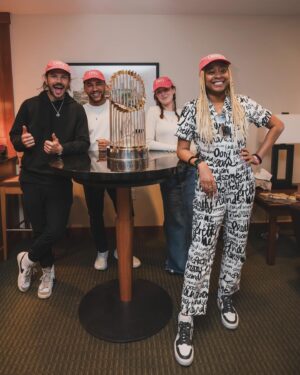 Phoebe Robinson Instagram - I CAN. FUCKING. DO. ANYTHING. I started running last March as a new hobby. Fell in love with it. Did some races. And last September, (RED) asked me to run this race for them. And I did it! Wow. Surprising yourself is the coolest thing! Cannot wait to do another marathon! 

Running the @bostonmarathon with a chest cold is a specific kind of masochistic hell. 10 out of 10 do not recommend. Haha. But for real, the race was a surreal, incredible, once in a lifetime experience. No matter how much you prep, train, when it’s race day, you just have to meet the moment & see what you’re really made of. I saw ppl vomiting, limping, struggling; my parents lost count of how many people they saw pass out at or near the finish line. The Boston Marathon is a beast like no other and sick or not, I refused to give up.

1) Post race right after I go my medal, my dad took this photo. I was so happy, tired, and proud of myself. Baby is a marathoner!
2) On Saturday, @bankofamerica invited me and the rest of Team (RED) to a Red Sox game and I got to represent (RED) on the field during special recognition before the game started. Jumpsuit: @wearewildfang 
3) Team @red - @dan_churchill, @jeffreymce, @bellezel & I - got to pose with the World Champion trophy. Neat!
4) My parents showed up looking fly AF in their matching Boston Marathon jackets that I got them. 🥰🥰
5) (RED) gang pre-race.
6) Me right before getting my marathon cherry popped.
7) Saw so many great signs thruout the race. This made me stop and laugh so hard.
8) Heartbreak Hill was no joke. Truly was hard. About 13 miles into the marathon, it felt like someone was pressing down/sitting on my chest, but I remained calm and stuck to my plan: running up HH, which was between miles 20 and 21 and lasted 1/2 mile, without stopping. And I did it!
9) This was towards the end. I was fighting for my life for the last 4 miles. I told myself to keep moving. Never stop. And remember my why: I’m doing this for (RED). It’s bigger than me. But also: this IS for me. To test myself mentally and physically.
10) My dad took the photo. He tidied up all the tables behind me because they were messy with food. #DadsOfInstagram #BostonMarathon