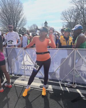 Phoebe Robinson Instagram - I CAN. FUCKING. DO. ANYTHING. I started running last March as a new hobby. Fell in love with it. Did some races. And last September, (RED) asked me to run this race for them. And I did it! Wow. Surprising yourself is the coolest thing! Cannot wait to do another marathon! 

Running the @bostonmarathon with a chest cold is a specific kind of masochistic hell. 10 out of 10 do not recommend. Haha. But for real, the race was a surreal, incredible, once in a lifetime experience. No matter how much you prep, train, when it’s race day, you just have to meet the moment & see what you’re really made of. I saw ppl vomiting, limping, struggling; my parents lost count of how many people they saw pass out at or near the finish line. The Boston Marathon is a beast like no other and sick or not, I refused to give up.

1) Post race right after I go my medal, my dad took this photo. I was so happy, tired, and proud of myself. Baby is a marathoner!
2) On Saturday, @bankofamerica invited me and the rest of Team (RED) to a Red Sox game and I got to represent (RED) on the field during special recognition before the game started. Jumpsuit: @wearewildfang 
3) Team @red - @dan_churchill, @jeffreymce, @bellezel & I - got to pose with the World Champion trophy. Neat!
4) My parents showed up looking fly AF in their matching Boston Marathon jackets that I got them. 🥰🥰
5) (RED) gang pre-race.
6) Me right before getting my marathon cherry popped.
7) Saw so many great signs thruout the race. This made me stop and laugh so hard.
8) Heartbreak Hill was no joke. Truly was hard. About 13 miles into the marathon, it felt like someone was pressing down/sitting on my chest, but I remained calm and stuck to my plan: running up HH, which was between miles 20 and 21 and lasted 1/2 mile, without stopping. And I did it!
9) This was towards the end. I was fighting for my life for the last 4 miles. I told myself to keep moving. Never stop. And remember my why: I’m doing this for (RED). It’s bigger than me. But also: this IS for me. To test myself mentally and physically.
10) My dad took the photo. He tidied up all the tables behind me because they were messy with food. #DadsOfInstagram #BostonMarathon