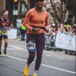 Phoebe Robinson Instagram - I CAN. FUCKING. DO. ANYTHING. I started running last March as a new hobby. Fell in love with it. Did some races. And last September, (RED) asked me to run this race for them. And I did it! Wow. Surprising yourself is the coolest thing! Cannot wait to do another marathon! Running the @bostonmarathon with a chest cold is a specific kind of masochistic hell. 10 out of 10 do not recommend. Haha. But for real, the race was a surreal, incredible, once in a lifetime experience. No matter how much you prep, train, when it’s race day, you just have to meet the moment & see what you’re really made of. I saw ppl vomiting, limping, struggling; my parents lost count of how many people they saw pass out at or near the finish line. The Boston Marathon is a beast like no other and sick or not, I refused to give up. 1) Post race right after I go my medal, my dad took this photo. I was so happy, tired, and proud of myself. Baby is a marathoner! 2) On Saturday, @bankofamerica invited me and the rest of Team (RED) to a Red Sox game and I got to represent (RED) on the field during special recognition before the game started. Jumpsuit: @wearewildfang 3) Team @red - @dan_churchill, @jeffreymce, @bellezel & I - got to pose with the World Champion trophy. Neat! 4) My parents showed up looking fly AF in their matching Boston Marathon jackets that I got them. 🥰🥰 5) (RED) gang pre-race. 6) Me right before getting my marathon cherry popped. 7) Saw so many great signs thruout the race. This made me stop and laugh so hard. 8) Heartbreak Hill was no joke. Truly was hard. About 13 miles into the marathon, it felt like someone was pressing down/sitting on my chest, but I remained calm and stuck to my plan: running up HH, which was between miles 20 and 21 and lasted 1/2 mile, without stopping. And I did it! 9) This was towards the end. I was fighting for my life for the last 4 miles. I told myself to keep moving. Never stop. And remember my why: I’m doing this for (RED). It’s bigger than me. But also: this IS for me. To test myself mentally and physically. 10) My dad took the photo. He tidied up all the tables behind me because they were messy with food. #DadsOfInstagram #BostonMarathon