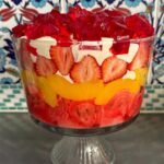 Poh Ling Yeow Instagram – Ok I finally got my shizen together this year & wrote a recipe for the retro Yeow trifle which is ‘special’ because it uses NO fresh ingredients bar the strawberries 🤔. Every time I’ve deviated ever so slightly into fancy, someone will comment “HOW INTERESTING YOU USED SOUR CHERRIES & HOMEMADE CUSTARD THIS YEAR” – code for “Why did you turn this into something unpredictable”. Anyhoo, i guess the moral is if it ain’t broke – enjoy! Merry Holidays everyone!!! ♥️⭐️ 

YEOW FAM RETRO TRIFLE
3 packets 🍓 or raspberry crystals 
4 Tbs powdered gelatine or 10g sheet gelatine 
1 x 6 pack mini jam rollettes, sliced 1.5cm
2 punnets strawberries, slice enough to cover the diameter of the trifle bowl, cut the rest into 1cm cubes. 
825g tin sliced peaches, drained 
2-3 cups custard (powdered kind – make using packet instructions or u can use home made creme patt of course) 
1 cup thickened cream, whipped with 2 Tbs full caster sugar & 1 tsp vanilla or strawberry essence until medium – stiff peaks

Make 2 packets of the jelly following the packet instructions but add the extra gelatine. Stir until all the crystals are dissolved then pour into a flat 25x20cm-ish tray or dish. Chill in fridge for 2 hours or until set firmly. 

Make the remaining packet of jelly using regular packet instructions. Set aside. 

Arrange the jam rollettes on the bottom of the triffle bowl (about 4L capacity). Pour the warm jelly mix over the rollettes making sure all the pieces are soaked through. 

Layer as follows: 1/2 of the custard, peaches, remaining 1/2 of the custard, strawberries, whipped vanilla cream. To finish, slice up your finger jello into cubes and rain them over the cream piling them as high as possible. Chill for 2 hours so the jelly in the bottom is set. Serve with a smol shovel, dive in and hope jelly cubes don’t wind up bouncing all over your mum’s carpet 🤭😚