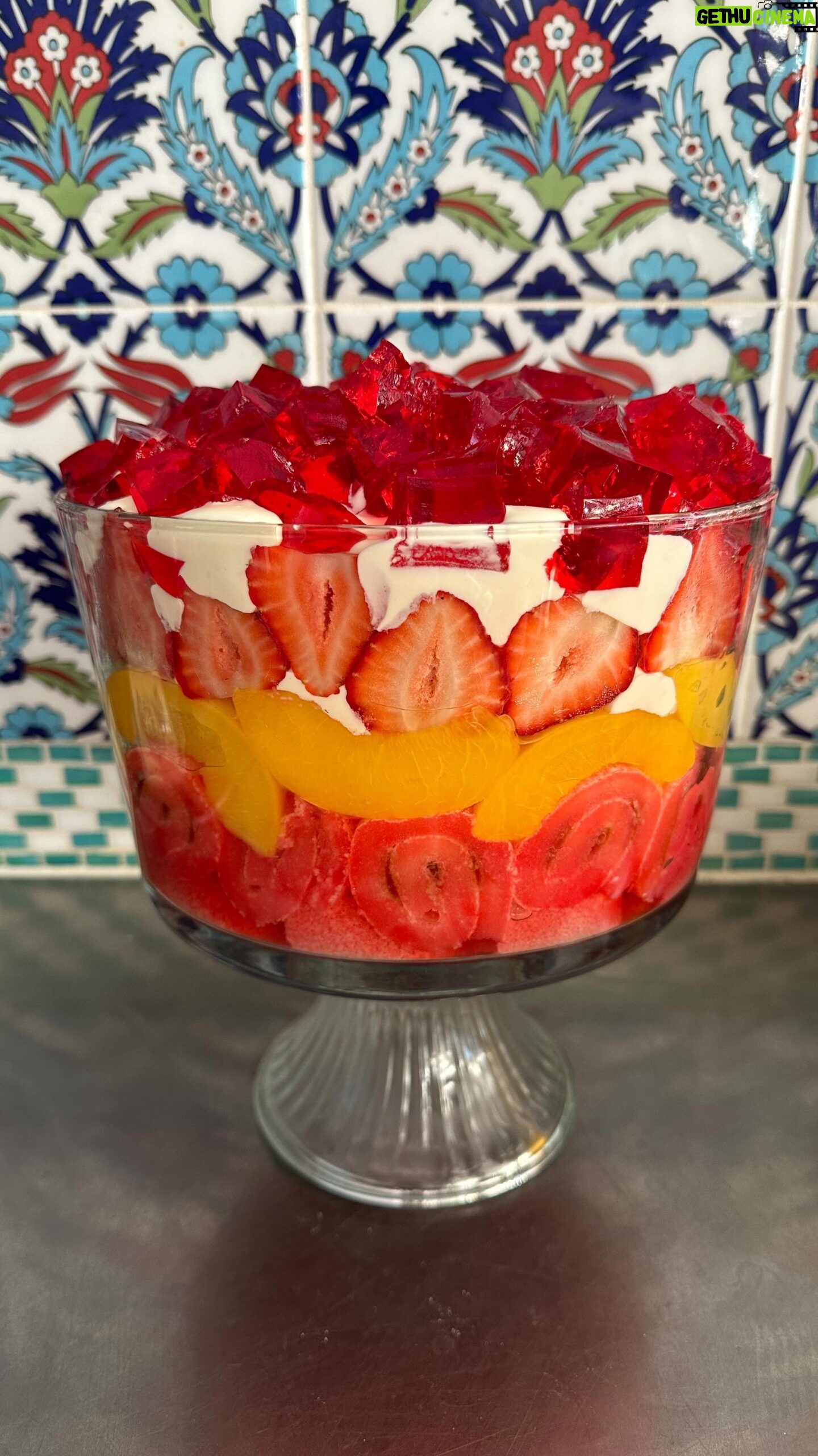 Poh Ling Yeow - 12.1K Likes - Ok I finally got my shizen together this year & wrote a recipe for the retro Yeow trifle which is ‘special’ because it uses NO fresh ingredients bar the strawberries 🤔. Every time I’ve deviated ever so slightly into fancy, someone will comment “HOW INTERESTING YOU USED SOUR CHERRIES & HOMEMADE CUSTARD THIS YEAR” - code for “Why did you turn this into something unpredictable”. Anyhoo, i guess the moral is if it ain’t broke - enjoy! Merry Holidays everyone!!! ♥️⭐️
YEOW FAM RETRO TRIFLE
3 packets 🍓 or raspberry crystals
4 Tbs powdered gelatine or 10g sheet gelatine
1 x 6 pack mini jam rollettes, sliced 1.5cm
2 punnets strawberries, slice enough to cover the diameter of the trifle bowl, cut the rest into 1cm cubes.
825g tin sliced peaches, drained
2-3 cups custard (powdered kind - make using packet instructions or u can use home made creme patt of course)
1 cup thickened cream, whipped with 2 Tbs full caster sugar & 1 tsp vanilla or strawberry essence until medium - stiff peaks
Make 2 packets of the jelly following the packet instructions but add the extra gelatine. Stir until all the crystals are dissolved then pour into a flat 25x20cm-ish tray or dish. Chill in fridge for 2 hours or until set firmly.
Make the remaining packet of jelly using regular packet instructions. Set aside.
Arrange the jam rollettes on the bottom of the triffle bowl (about 4L capacity). Pour the warm jelly mix over the rollettes making sure all the pieces are soaked through.
Layer as follows: 1/2 of the custard, peaches, remaining 1/2 of the custard, strawberries, whipped vanilla cream. To finish, slice up your finger jello into cubes and rain them over the cream piling them as high as possible. Chill for 2 hours so the jelly in the bottom is set. Serve with a smol shovel, dive in and hope jelly cubes don’t wind up bouncing all over your mum’s carpet 🤭😚