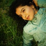 Ranjitha Menon Instagram - Infused with the scent of earth and life! Immersed in the embrace of nature’s green hue! With every touch, she connects with the soil beneath her, feeling the cool blades of grass caress her skin, grounding her in the present moment, away from the worries of yesterday and uncertainties of tomorrow. #earth #nature #solace #life #green 📷 @arunchandu