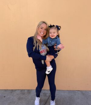 Sabrina Bryan Instagram - This season has a little extra sparkle dust for this momma bear! So happy to be back to watch my girls light the floor up in person and have our little Mustang Mascot right next to me! 🥰💙🎶❤️ #mustangpride #comilliamonroe