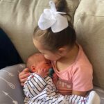 Sabrina Bryan Instagram - The best gift I could have ever given my babies is each other. From the first time Monroe saw her baby brother I knew she was going to be the best big sister and that he would have a best friend and protector for life! 💙🩷 #monroemeetingbabyledger #bestiesforlife #bestfriend #comilliamonroe #ledgergrey #monroeandledger #adventuresofthelundbergs