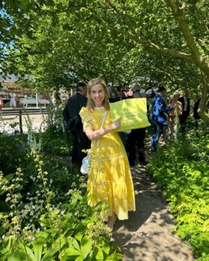 Sally Phillips Instagram - The winners of #rhschelseaflowershow are announced tomorrow but I got a sneak peak at the contenders today thanks to the excellent Gardens for Good- check them out on @project.giving.back #gardensforgoodcauses.  Such a great day, lucky me. And so nice to hang out with funny doctor @michaelakadiri funny queen @elliejanetaylor dramatically skilled baker and seamstress #janeasher and Oscar nominee of the future @fehintibalogun. Also hilarious.

Project Giving Back was founded by two philanthropists who had the idea of giving the significant platform (and springboard) of a Chelsea Flower Show garden to community interest groups, educational organisations and charities within the UK so they can raise awareness and engage with their audience. Hard to believe now but all the Chelsea gardens used to be put in a skip once the week was up. All of these gardens are repurposed or relocated to a permanent home afterwards - going out when the flower show is over to schools, hospitals, therapeutic settings and community spaces so they have a long-lasting legacy.
A feast for the eyes but also the heart. Loved meeting Jessie and @officialdanielwakeford at @pulpfrictioncic Growing Skills Garden and Adil and the kids at @panathlon_international Joy Garden.
Thought of @darrenashton and all you great #survivors in the @bowelresearchuk Microbione garden - a meadow of edible flowers complete with dormouse nest and cracked hazelnut shells designed by @chrishullgardens and @sidhillecogardens . @nationalautisticsociety garden featured giant marble run, @musculardystrophyuk a beautiful haven, but was stopped in my tracks by the @freedomfromtorture Garden : A Sanctuary for Survivors by @johnwarland and @emmaoconnellgardendesign .
 Thanks to @annie_miall as per, to @cefinnstudio for the loan of the beautiful yellow frock which I am definitely going to buy and to @aspinaloflondon for the bag. Hair and make-up by.,, whoops should probably have got help with that.