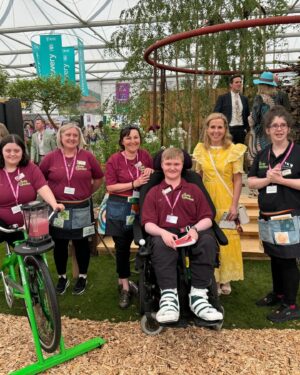 Sally Phillips Instagram - The winners of #rhschelseaflowershow are announced tomorrow but I got a sneak peak at the contenders today thanks to the excellent Gardens for Good- check them out on @project.giving.back #gardensforgoodcauses.  Such a great day, lucky me. And so nice to hang out with funny doctor @michaelakadiri funny queen @elliejanetaylor dramatically skilled baker and seamstress #janeasher and Oscar nominee of the future @fehintibalogun. Also hilarious.

Project Giving Back was founded by two philanthropists who had the idea of giving the significant platform (and springboard) of a Chelsea Flower Show garden to community interest groups, educational organisations and charities within the UK so they can raise awareness and engage with their audience. Hard to believe now but all the Chelsea gardens used to be put in a skip once the week was up. All of these gardens are repurposed or relocated to a permanent home afterwards - going out when the flower show is over to schools, hospitals, therapeutic settings and community spaces so they have a long-lasting legacy.
A feast for the eyes but also the heart. Loved meeting Jessie and @officialdanielwakeford at @pulpfrictioncic Growing Skills Garden and Adil and the kids at @panathlon_international Joy Garden.
Thought of @darrenashton and all you great #survivors in the @bowelresearchuk Microbione garden - a meadow of edible flowers complete with dormouse nest and cracked hazelnut shells designed by @chrishullgardens and @sidhillecogardens . @nationalautisticsociety garden featured giant marble run, @musculardystrophyuk a beautiful haven, but was stopped in my tracks by the @freedomfromtorture Garden : A Sanctuary for Survivors by @johnwarland and @emmaoconnellgardendesign .
 Thanks to @annie_miall as per, to @cefinnstudio for the loan of the beautiful yellow frock which I am definitely going to buy and to @aspinaloflondon for the bag. Hair and make-up by.,, whoops should probably have got help with that.