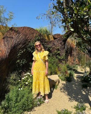 Sally Phillips Instagram - The winners of #rhschelseaflowershow are announced tomorrow but I got a sneak peak at the contenders today thanks to the excellent Gardens for Good- check them out on @project.giving.back #gardensforgoodcauses.  Such a great day, lucky me. And so nice to hang out with funny doctor @michaelakadiri funny queen @elliejanetaylor dramatically skilled baker and seamstress #janeasher and Oscar nominee of the future @fehintibalogun. Also hilarious.

Project Giving Back was founded by two philanthropists who had the idea of giving the significant platform (and springboard) of a Chelsea Flower Show garden to community interest groups, educational organisations and charities within the UK so they can raise awareness and engage with their audience. Hard to believe now but all the Chelsea gardens used to be put in a skip once the week was up. All of these gardens are repurposed or relocated to a permanent home afterwards - going out when the flower show is over to schools, hospitals, therapeutic settings and community spaces so they have a long-lasting legacy.
A feast for the eyes but also the heart. Loved meeting Jessie and @officialdanielwakeford at @pulpfrictioncic Growing Skills Garden and Adil and the kids at @panathlon_international Joy Garden.
Thought of @darrenashton and all you great #survivors in the @bowelresearchuk Microbione garden - a meadow of edible flowers complete with dormouse nest and cracked hazelnut shells designed by @chrishullgardens and @sidhillecogardens . @nationalautisticsociety garden featured giant marble run, @musculardystrophyuk a beautiful haven, but was stopped in my tracks by the @freedomfromtorture Garden : A Sanctuary for Survivors by @johnwarland and @emmaoconnellgardendesign .
 Thanks to @annie_miall as per, to @cefinnstudio for the loan of the beautiful yellow frock which I am definitely going to buy and to @aspinaloflondon for the bag. Hair and make-up by.,, whoops should probably have got help with that.
