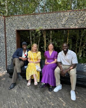 Sally Phillips Instagram - The winners of #rhschelseaflowershow are announced tomorrow but I got a sneak peak at the contenders today thanks to the excellent Gardens for Good- check them out on @project.giving.back #gardensforgoodcauses.  Such a great day, lucky me. And so nice to hang out with funny doctor @michaelakadiri funny queen @elliejanetaylor dramatically skilled baker and seamstress #janeasher and Oscar nominee of the future @fehintibalogun. Also hilarious.

Project Giving Back was founded by two philanthropists who had the idea of giving the significant platform (and springboard) of a Chelsea Flower Show garden to community interest groups, educational organisations and charities within the UK so they can raise awareness and engage with their audience. Hard to believe now but all the Chelsea gardens used to be put in a skip once the week was up. All of these gardens are repurposed or relocated to a permanent home afterwards - going out when the flower show is over to schools, hospitals, therapeutic settings and community spaces so they have a long-lasting legacy.
A feast for the eyes but also the heart. Loved meeting Jessie and @officialdanielwakeford at @pulpfrictioncic Growing Skills Garden and Adil and the kids at @panathlon_international Joy Garden.
Thought of @darrenashton and all you great #survivors in the @bowelresearchuk Microbione garden - a meadow of edible flowers complete with dormouse nest and cracked hazelnut shells designed by @chrishullgardens and @sidhillecogardens . @nationalautisticsociety garden featured giant marble run, @musculardystrophyuk a beautiful haven, but was stopped in my tracks by the @freedomfromtorture Garden : A Sanctuary for Survivors by @johnwarland and @emmaoconnellgardendesign .
 Thanks to @annie_miall as per, to @cefinnstudio for the loan of the beautiful yellow frock which I am definitely going to buy and to @aspinaloflondon for the bag. Hair and make-up by.,, whoops should probably have got help with that.