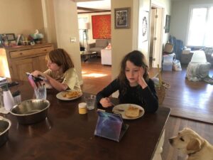 Samantha Power Instagram - Morning scene: Veggie scramble. Books for the old fashioned and modern readers. Slime container close at hand. Snowy on guard for falling debris.