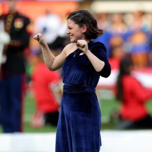 Sandra Mae Frank Instagram - This has been an incredible journey to perform at the #SuperBowlLVI this year in Los Angeles!

I am honored to join the group of deaf legendaries that have performed #NationalAnthem and #AmericaTheBeautiful in the past at #SuperBowl. 

I can’t wait to pass the torch to the next one!

It’s been an incredible year of deaf representations in the entertainment industry worldwide. Yes, we still have more work to do as we continue to thrive the way for the future generations of deaf performers/entertainers/creators in the entertainment industry. We are in this together! #LETSGO

Many more to come! 🔥

Thanks to @NAD1880 for a great opportunity! 🤟🏻🤗

Also, #WawaSnipe & #SeanForbes were on fire performing the HalfTime Show! #ShoSumLuv! 😎

Photo - #KevinCCox
Outfit - @SomethingNavy
MHU - @Leibi_Carias 
ILY Necklace - @RoseByander 

#DeafArtists #Singers #ASL #MickeyGuyton #JheneAiko #DeafMusicArtists #DeafAndLoud #Joy #PreShow #HalfTimeShow #LGBTQ🌈

[image description]
Photo 1 - Sandra Mae, short wavy hair, wearing a stunning royal blue jumpsuit with a partial long sleeve, ILY necklace, and pride progress pin. Both of her hands are up and closed. She is smiling.
Photo 2 - Same look as photo 1, but her hands are now open, and she’s smiling bigger.