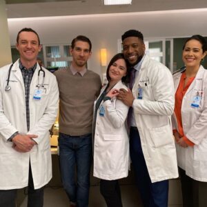 Sandra Mae Frank Instagram - #AppreciationPost: My journey with #NewAmsterdam has been nothing but full of #joy, #laughs, #challenges, #respect, and more. I’ve learned a lot from my peers on set as an #actor and I’m more than honored to play #DrWilder, the #badass #deaf #oncologist breaking barriers and proving that we can do anything. 

Dream big and defy the norms. Go for the stars and soar.

#Season4 #finale tomorrow night at 10/9c on #NBC, #Hulu & #PeacockTV the next day. You’re in for a #WILD ride!

#DamFam #WithLove 💙

[image description]
Five people standing together, smiling. From left to right, all wearing doctor lab coats, the second on the left is wearing blue jeans with tan long sleeve.