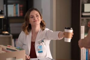Sandra Mae Frank Instagram - Need coffee? Wilder got you. 😎

All new tonight on #NBC, next day on #Peacock 

#DamFam #NewAmsterdam #DrWilder #NeedCoffee?

[image description]
Sandra Mae as Dr. Wilder, in her lab coat, sitting behind a table. She smiles as she hands the coffee in her hand.
