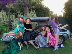Sara Rue Instagram - My Mom friends... and a DeLorean!  #80sprom.  I've never gotten to go to a prom. I'm so glad this was my first ...
I love these ladies 💜👗🎉 #unsolicitedlifeadvice get yourself a community of strong, kind, badass women who will lift you up, bring your family soup when you have Covid and aren't afraid to dress up like crazy people for a school function! @jennafbans @elizabethbogush @sbedethompson @ellisjm @mimi_karsh 💜💜💜