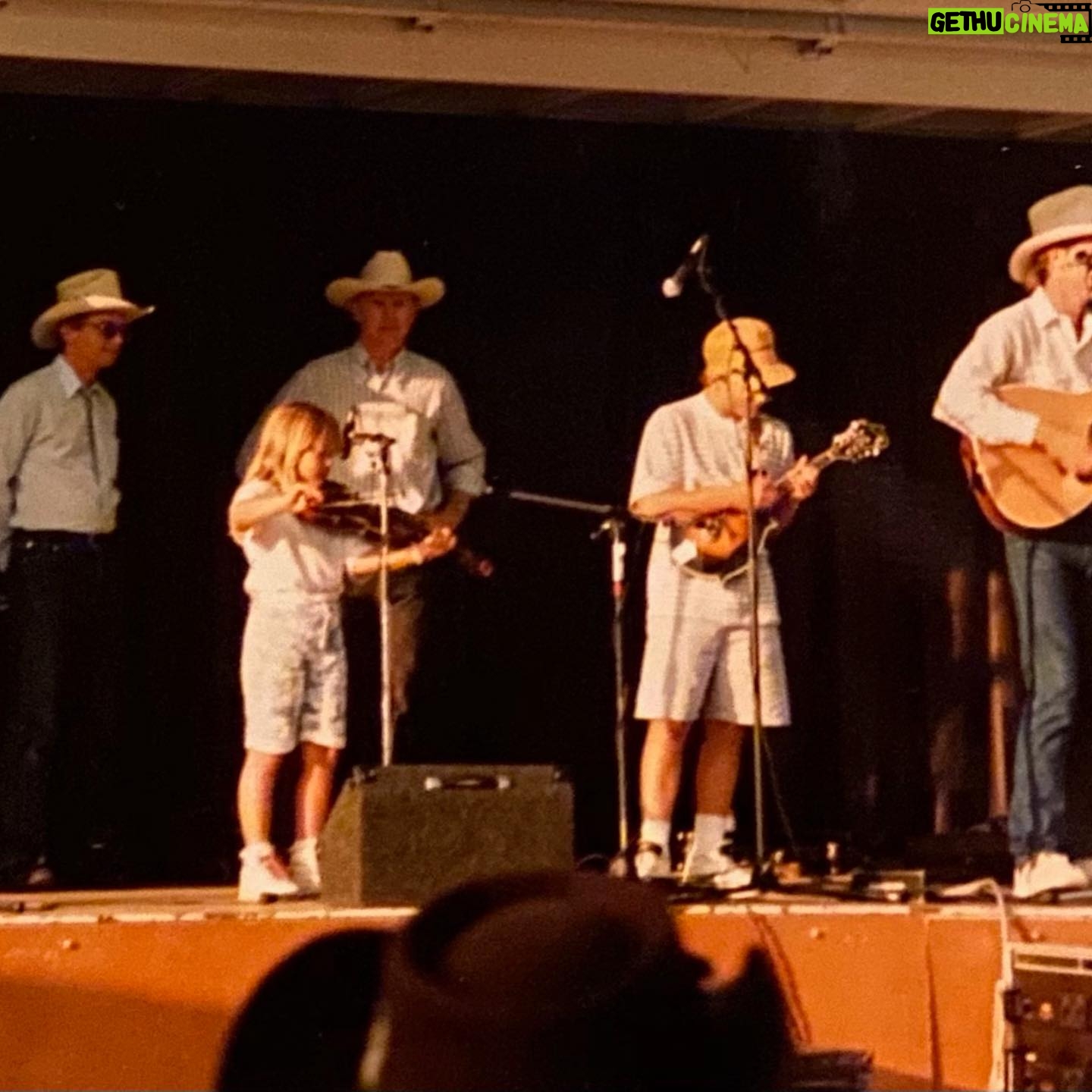 Sara Watkins - 1.6K Likes - This weekend we lost a legendary fiddler, and a man who hugely influenced so many of us when we were coming up as young players. When I was about 8, he sold me my first good fiddle - a 3/4 size. It was way too big for me for at least a year or two but it sounded great and I was so proud that I got it from Byron. That’s the one I’m playing in these first two photos. Alison Kraus was playing our favorite local festival called Follows Camp, and Byron organized a jam so all of us kids could play with her. Byron, his wife Bette and daughter Becca were always welcoming and my heart and love are with them. I remember going to their house shortly after the Northridge earthquake and he told stories of near misses and mentioned after the quake, the water level of his pool was a foot lower, and all the fruit on that side of the orange tree had been knocked to the ground. Seemingly from a big wave. It’s funny the things that stick with you.
If we came to one of Byron’s shows, be it with “The LA Fiddle Band” or “California” or anything else, he’d almost always invite us up to play on a tune with them. It made me want to work so I’d be deserving of the opportunity if and when the next chance came in hopes he’d see that I’d been practicing. Throughout his long influential life, Byron took so many of us young players under his wing and taught us about performing and jamming by example. I’m so grateful for his contribution to my life, and for his bow arm that, to me, defined his style. I have so many memories of being around Byron, I wish I had more photos, but I’m grateful for these which my parents and aunt Joanie recently sent my way.