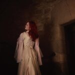 Sasha Alsberg Instagram - The princess in the tower…a love story or a life sentence? 🖤 #cuedramaticmusic • • • I am in absolute awe with how these photos turned out. Stephen and Sara from @manorandmaker truly captured the vision! See that stunning layered skirt? Well, Sara made it in about 2 minutes with just pins holding it together. Just wow! #OfWhimsicalMoments #everydaymagic #TheHappyNow #chateaucore #quietinthewild #redhead #france #southoffrance #frenchcountryside #historicaldress #periodfashion #cottagecore #littlewanderersdiary #folkandstory #booknymph #bookstagram #authorsofinstagram #writingretreat #frenchchateau #medevielfashion