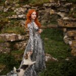 Sasha Alsberg Instagram - 👑 She never cared for a crown. She preferred a sword. 🗡️ this dress makes me feel like I stepped off the pages of a book. I wonder what the title would be…. Dress: @aclotheshorse’s from @chotronette (SO BEYOND STUNNING!) Photo by: @friendofthekingfisher #ireland #ladyknight #romanticacademia #womenwithswords #darkacademia #booktok #tog #fantasybooks #fairycore #faerie #visitnorthernireland
