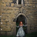 Sasha Alsberg Instagram - 👑 She never cared for a crown. She preferred a sword. 🗡️ this dress makes me feel like I stepped off the pages of a book. I wonder what the title would be…. Dress: @aclotheshorse’s from @chotronette (SO BEYOND STUNNING!) Photo by: @friendofthekingfisher #ireland #ladyknight #romanticacademia #womenwithswords #darkacademia #booktok #tog #fantasybooks #fairycore #faerie #visitnorthernireland