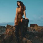 Serinda Swan Instagram – This shoot was taken in the desert at Mojave Moon Ranch, and right as the sun was setting we ran to the top of this mountain for the most beautiful light Definitely not easy in these boots, but the picture was well worth it. 😂
Exclusive for @ladygunn
Photography: Valerie Burke @burkephotography
Stylist: Sofia Popkova @iamsofiapopkova @stylebysofiapopkova
Make Up: Marlena Von Kazmier @marlenavonkazmier_mua
Hair: Olya Romanenko @o.r.hair
Styling Assist: Anastasia Buriak @aintsweetlikesuga & Oksana Masalyko @oxanamas
Wearing:
Leather dress: @attickoncept
Boots: @berhasm_global – @tata_la
Necklace: @attickoncept