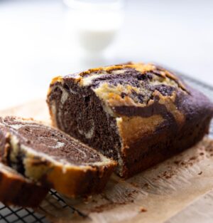 Silvia Colloca Instagram - I make this tea cake more than I make tea! It’s so so good. Look at those hypnotic swirls of cocoa and @illyinaustralia 
Espresso and Vanilla Swirl Loaf Cake

From my new show @silviasitalianmasterclass 
Ingredients

3 eggs
180 gr  caster sugar
200 gr  self-raising flour
65 gr  almond meal
60 ml (1/4 cup) extra virgin olive oil
1/2 cup (125ml) Buttermilk
1 teaspoon of vanilla extract
3 tablespoons of dark cocoa
50 ml of espresso (replace with same amount of warm milk or water if coffee is not your vibe)

Method

Preheat the oven to 180C. Grease a loaf tin. 
Whisk eggs and sugar until pale and creamy.
Add the oil, buttermilk and the vanilla.
Gently fold in the flour, well sifted. Mix until the batter is combined, then add almond meal and mix to combine.
Pour 1/2 of the mix into one bowl and the other half into another bowl along with the cocoa powder and espresso. Evenly dollop batter into the baking tin alternating between both mixtures to create a swirl pattern.  Add 3 tablespoons of dark cocoa and the espresso to the remaining cake batter and mix until smooth.
Dollop the cocoa mix on top of the vanilla mix and , using a fork or a chopstick, to swirl the two batters together. Bake for 35-40 minutes, or until a skewer comes out clean. Allow to cool before serving.
@channel10au @10playau