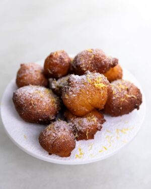 Silvia Colloca Instagram - These 5 minutes donuts are so easy to make it’s criminal! Their ineffable lightness is a combination of @floridiacheese ricotta and @sanpellegrino_aus limonata!
Remember you can catch my new show @silviasitalianmasterclass on @channel10au on Saturday at 12.30 or anytime on @10playau 
🇮🇹❤️

Ricotta and Lemonade Zeppole
Ingredients

2 eggs, lightly beaten 
2 tbsp. caster sugar 
1-1/4 cup of ricotta,  well drained 
120g of sifted self raising flour 
Finely grated zest of 1 lemon 
75 ml of sparkling limonata
vegetable oil for deep frying
Icing sugar for dusting on top
Method

Combine ricotta, eggs, sugar, zest in a medium bowl. 
Add the flour and limonata and mix gently. This batter is very 
forgiving and a few lumps are an addition to the texture. 
Pour oil into a shallow saucepan, and heat over medium-high heat. 
Drop tablespoon of batter into the hot oil and fry, in batches, for 2-3 minutes or until golden.
Drain on paper towels and serve hot, dusted with icing sugar.