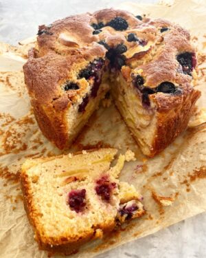 Silvia Colloca Instagram - Giving in to these soft autumnal mornings with a warm apple and berry cake. 💕

100 g unsalted butter, melted
4 medium Granny Smith apples, peeled, cored and thinly sliced 
½ medium lemon, zest and juice
pinch of salt
2 cups self-raising flour
2 large eggs
200 g (scant 1 cup) soft brown sugar
150 ml apple sauce
1 punnet fresh blackberries or blueberries/raspberries 
whipped thickened cream, for serving

1. Preheat the oven to 170ºC. Line the base and sides of a 20 cm round tin with baking paper. Toss the sliced apples in a bowl with the lemon juice and zest and set aside.

2. In a separate bowl whisk the eggs with the sugar. Add salt. Sift in the flour, mix then add the apple sauce and the melted butter. Mix the apple slices through and half of the blackberries.

3. Pour the batter in the tin, level with a spoon and top with remaining blackberries. Bake for about 60-65 minutes. The top should be caramel brown and the cake soft-yet-firm to touch. To be sure, insert a stick into the middle of the cake, if it comes out clean, the cake is baked, otherwise give it another 2-3 minutes and test again.

4. Cool in the tin for 1 hour, then transfer to a plate and serve with whipped cream.