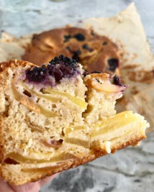 Silvia Colloca Instagram - Giving in to these soft autumnal mornings with a warm apple and berry cake. 💕

100 g unsalted butter, melted
4 medium Granny Smith apples, peeled, cored and thinly sliced 
½ medium lemon, zest and juice
pinch of salt
2 cups self-raising flour
2 large eggs
200 g (scant 1 cup) soft brown sugar
150 ml apple sauce
1 punnet fresh blackberries or blueberries/raspberries 
whipped thickened cream, for serving

1. Preheat the oven to 170ºC. Line the base and sides of a 20 cm round tin with baking paper. Toss the sliced apples in a bowl with the lemon juice and zest and set aside.

2. In a separate bowl whisk the eggs with the sugar. Add salt. Sift in the flour, mix then add the apple sauce and the melted butter. Mix the apple slices through and half of the blackberries.

3. Pour the batter in the tin, level with a spoon and top with remaining blackberries. Bake for about 60-65 minutes. The top should be caramel brown and the cake soft-yet-firm to touch. To be sure, insert a stick into the middle of the cake, if it comes out clean, the cake is baked, otherwise give it another 2-3 minutes and test again.

4. Cool in the tin for 1 hour, then transfer to a plate and serve with whipped cream.