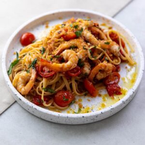 Silvia Colloca Instagram - Doesn’t get more Italian that this!
Linguine with Roasted Tomatoes, Prawns and Chilli Lemon Pangrattato

A recipe from my new show @silviasitalianmasterclass featuring @barillaaus al bronzo linguine (perfect for the al dente texture) and @ooni.anz  outdoor oven to create the most delicious tomato and prawn sauce. And if you don’t feel like cooking this yourself, order this dish on @providoor !
Head to @silviasitalianmasterclass to enter a giveaway to win your own @ooni.anz! 
Ingredients

1x packet Linguine 
600 g cherry tomatoes
⅓ cup (80ml) extra virgin olive oil
clove garlic, skin on, bashed with the back of a knife 
2 spring onions, thinly sliced
1 small handful flat-leaf parsley stalks
pinch of sugar
salt flakes
16 tiger prawns, peeled and de-veined
2 tablespoons extra virgin olive oil
1 small handful flat-leaf parsley stalks, finely chopped
1 teaspoon salt flakes
1 clove garlic, finely chopped
for the pangrattato

2 thick slices of stale sourdough
1 peeled garlic clove
1 red chilli (or bird’s eye)

Full method in comments or head to silviasitalianmasterclass.com for full recipe and video recipe