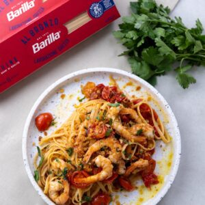 Silvia Colloca Instagram - Doesn’t get more Italian that this!
Linguine with Roasted Tomatoes, Prawns and Chilli Lemon Pangrattato

A recipe from my new show @silviasitalianmasterclass featuring @barillaaus al bronzo linguine (perfect for the al dente texture) and @ooni.anz  outdoor oven to create the most delicious tomato and prawn sauce. And if you don’t feel like cooking this yourself, order this dish on @providoor !
Head to @silviasitalianmasterclass to enter a giveaway to win your own @ooni.anz! 
Ingredients

1x packet Linguine 
600 g cherry tomatoes
⅓ cup (80ml) extra virgin olive oil
clove garlic, skin on, bashed with the back of a knife 
2 spring onions, thinly sliced
1 small handful flat-leaf parsley stalks
pinch of sugar
salt flakes
16 tiger prawns, peeled and de-veined
2 tablespoons extra virgin olive oil
1 small handful flat-leaf parsley stalks, finely chopped
1 teaspoon salt flakes
1 clove garlic, finely chopped
for the pangrattato

2 thick slices of stale sourdough
1 peeled garlic clove
1 red chilli (or bird’s eye)

Full method in comments or head to silviasitalianmasterclass.com for full recipe and video recipe