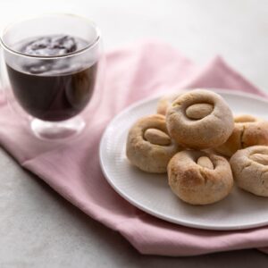 Silvia Colloca Instagram - A little sweet moment, with all the Italian flaire. We do hot chocolate thick and dense…. Highly addictive… add a touch of @illyinaustralia for an extra boost! 
@silviasitalianmasterclass 

Italian Style Espresso Hot Chocolate with Almond Cookies
Ingredients

For the hot chocolate 

Serves 2

2 tbs Dutch cocoa powder 
80 g (1/3 cup) caster sugar
2 scant tablespoons cornflour
1/2 teaspoon vanilla bean paste
500 ml (2 cups) milk
2 shots of freshly brewed espresso coffee
2 tablespoons dark chocolate chips 

Method

Combine the cocoa, caster sugar, cornflour, vanilla  in a small saucepan.

Pour in 3 tablespoons of the milk and whisk until the mixture turns into a sticky, dark brown paste. Slowly add the rest of the milk, whisking enthusiastically as you go to prevent any lumps from forming. Add the espresso shots and stir through.

Place the saucepan over medium heat and bring to a simmer, stirring constantly with a wooden spoon or spatula. Reduce the heat to low, add the chocolate chips and cook, stirring, for 2–3 minutes or until the hot chocolate starts to thicken. Turn off the heat, serve hot.

For the almond cookies

makes 18

2 egg whites, at room temperature
170 g caster sugar, plus extra for rolling the cookies in
300 g almond meal
2 teaspoons vanilla extract or paste
finely grated zest of 1 lemon
18 blanched almonds
Method

Preheat your oven to 160°C fan forced, 180 C conventional

Place almond meal in a large bowl, add vanilla, lemon zest and egg whites and mix with your hands to form a paste.

Shape the paste into balls, roll them in the sugar, then gently push your thumb into the middle of each ball and top with a blanched almond 

Place the cookies in a baking tray lined with baking paper and bake for 18-20 minutes or until the base of the amaretti looks firm and slightly golden.

Cool them on a rack for at least 10 minutes before eating