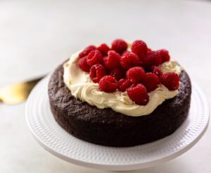 Silvia Colloca Instagram - The most delicious, decadent and satisfying chocolate cake! None of the gluten and all of flavour! With hints of hazelnut and the boost of @illyinaustralia to make the chocolate more chocolat-ty!
@silviasitalianmasterclass @10playau @channel10au 

 150 gr of unsalted butter
160 gr of 70 % dark chocolate
45 gr of dutch cocoa powder
50 ml espresso coffee
1 teaspoon of vanilla extract
200 gr of firmly packed brown sugar
4 eggs
120 gr of hazelnut meal
Pinch of salt
Serve with mascarpone and berries

1. Heat your oven to 160 C
2. Melt the butter with the chocolate in a double boiler
3. Pour the hot coffee into a bowl with the cocoa powder and whisk until there are no lumps. Add the
vanilla and mix. Add the cocoa mixture to the buttery melted chocolate and stir to combine.
4. In a separate bowl, cream the yolks with the sugar with a whisk or an electric beater until fluffy then pour
in the chocolate mixture. Add the hazelnut meal and stir to combine.
5. In a clean, dry bowl, beat the egg whites with a pinch of salt until soft peaks form. This will take about 1
minute if using a hand-held electric beater. A fair bit more if doing by hand...Gently fold the egg whites through the chocolate mixture using a large metal spoon. Pour the batter into a 20 cm round cake tin, lined with baking paper. Bake for 40/45 minutes or until the edges are firm and the surface it slightly cracked and feels soft in the middle.
6. Once cool it can be topped with strawberries, berries cherries, and mascarpone, cream or both!

Serving plate by @maxwellandwilliamsofficial