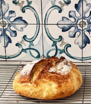 Silvia Colloca Instagram - Ready for breakfast! 💕
1/2 tsp dried yeast
550 g tipo 00 flour
50 g finely-ground semolina (plus extra for dusting)
1 tsp salt
Method

(start this recipe the night before to allow the dough to prove overnight. The following day, allow for an additional 1-2 hours of proving time before baking)
Place 1.5 tsp of yeast and 500 ml (2 cups) lukewarm water in a jug and stir to dissolve. Leave for 5 minutes to activate.
Place 550 g plain flour and 50 g fine semolina in a large bowl. Add the yeasted water and mix to combine. Add 1 tsp salt and mix until roughly combined.
Cover with a cloth and allow to prove overnight at room temperature or until doubled in size. If it’s really hot, try to find a cooler spot in the house, otherwise, it will rise too fast and you’ll miss out on the fermented flavour. 
Lift the risen dough out of the bowl and onto a floured benchtop. Give it a quick knead to bring it together. Stretch into a rectangle, then fold the dough onto itself in a ball. Place the dough, seam-side down in a colander dusted with semolina. Cover with a cloth and stand at room temperature for 1-2 hours or until risen by two-thirds.
To test if the dough is ready, poke it gently with a finger. If the indent is deep and doesn’t spring back at all, it has risen too much. You can still bake it but handle it with care or it will deflate (and don’t score an over-proved dough). If it springs back straight away it needs a little longer. If the finger leaves a little indent but the dough almost completely springs back, then it’s ready to bake.
Sprinkle the top of the dough with semolina and slash with a knife (this will encourage the bread to bloom and cook). 
Preheat oven to 250°C fan-forced (270°C conventional).
Place the bread onto a tray lined with baking paper, then bake for 45-50 minutes until the crust turns to a dark caramel colour.
Remove from the oven, tip the bread onto a wire rack (removing the baking paper if still attached) and cool for at least 1 hour before slicing. Resist the temptation to cut into the bread early: the crumb keeps cooking while the bread is cooling down and cutting into hot bread will interfere with this important step.