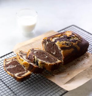 Silvia Colloca Instagram - I make this tea cake more than I make tea! It’s so so good. Look at those hypnotic swirls of cocoa and @illyinaustralia 
Espresso and Vanilla Swirl Loaf Cake

From my new show @silviasitalianmasterclass 
Ingredients

3 eggs
180 gr  caster sugar
200 gr  self-raising flour
65 gr  almond meal
60 ml (1/4 cup) extra virgin olive oil
1/2 cup (125ml) Buttermilk
1 teaspoon of vanilla extract
3 tablespoons of dark cocoa
50 ml of espresso (replace with same amount of warm milk or water if coffee is not your vibe)

Method

Preheat the oven to 180C. Grease a loaf tin. 
Whisk eggs and sugar until pale and creamy.
Add the oil, buttermilk and the vanilla.
Gently fold in the flour, well sifted. Mix until the batter is combined, then add almond meal and mix to combine.
Pour 1/2 of the mix into one bowl and the other half into another bowl along with the cocoa powder and espresso. Evenly dollop batter into the baking tin alternating between both mixtures to create a swirl pattern.  Add 3 tablespoons of dark cocoa and the espresso to the remaining cake batter and mix until smooth.
Dollop the cocoa mix on top of the vanilla mix and , using a fork or a chopstick, to swirl the two batters together. Bake for 35-40 minutes, or until a skewer comes out clean. Allow to cool before serving.
@channel10au @10playau