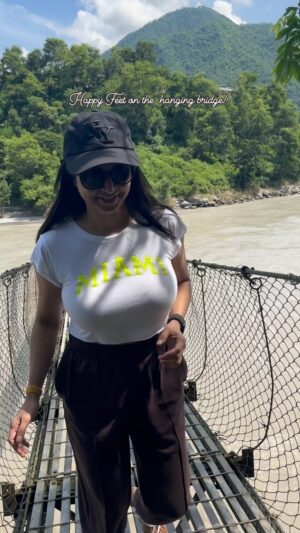 Sunitha Varma Instagram - Hanging loose (literally!) on this incredible bridge!  Such a thrilling way to experience the beauty of nature 🤩 #happyfeet 
.
.
.
#neverstopexploring #beautifuldestinations #nepal #hangingbridge #bagmatibridge #instatravel #trendingsongs