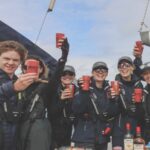 Talulah Riley Instagram – 🏴‍☠️ Hanging (literally) at the top of the mast of a 52’ yacht… @cowes_week was awesome fun 🏴‍☠️ 

🌊 We came last in our race. By 40 minutes. The spinnaker sheet got tangled around our engine. We tore our jig-sail. The cutlery drawer below deck came out and sent knives and forks whizzing everywhere. And we bumped into a huge yacht when mooring… but everyone kept their full compliment of fingers, and no one got hit on the head by the boom. 🌊 

💙 A BIG thank-you to @mustoclothing for kitting us out with proper sailing gear. I have loved you forever (used to wear your jackets out riding as a little girl). And thank you @chathamfootwear — not worn boat shoes before and now never want to take them off. They’re as comfortable as slippers!! 💙

🍹It was exciting when the  @mountgayrum boat came and delivered drinks (even kindly providing ginger beer for us non-drinkers. Or maybe I stole the mixer..?). Thomas was so rum-happy he held his cup right in front of my face for the photo…🍹

🦞 Oh, and I got so very sunburnt that my lips actually swelled up. I didn’t know that could happen. 🦞

✨We had the calmest, nicest skipper imaginable. Thank you very much @germaine_sail ✨

And top, top, talented team mates: @victorilou @charlottehawkins1 @chrisrobshawrugby @camillakerslake 

📸 Thank you @maxcisottiphotographer for your excellent company and action shots 📸 

And thank you @zafrushdie and @greenroomvip for the whole experience xx