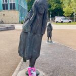 Talulah Riley Instagram - What a fun idea! I believe in book-fairies! 🖤💗 Repost from @jojoandthefloof • The Book Fairies have hidden a proof copy of ‘The Quickening’ by Talulah Riley next to a sculpture called ‘Cry for Justice – the Scream’, created by the artist Fenwick Lawson. Will you be lucky enough to spot this copy and take it home with you today? About the book: Years ago, Dana Mayer had a vision of a better world: one where women are in charge. The novel imagines the re-building of society after a lot of unrest (pandemic and nuclear war) with a group of women who step up to lead the new society. Dana’s manifesto, The Quickening, has established the rules for a new order, designed to elevate and protect women. A genteel and peaceful society that prioritises nature, good manners and aesthetics. Of course, in order for women to maintain control, the freedoms of men have been necessarily limited. Arthur Alden loves Dana Mayer but hates the world she has created. But can he find a way to resist, without losing everything? And with Dana intent on making men pay reparations for their past crimes, can Arthur be allowed to live without punishment? #hodderbookfairies #hodderbooks #ibelieveinbookfairies #proofbook #TheQuickening #TalulahRiley #cryforjusticethescream #durhamuniversity