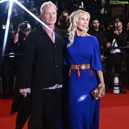 Trudie Styler Instagram - Sting and me almost breaking into a quickstep on the red carpet at the 77th Cannes Film Festival for the premiere of Oscar-winning director, writer and producer #PaoloSorrentino’s film ‘Parthenope’ earlier this week! Thank you dear friend Malgo @szumowska.m for this great clip. #Valentino dress, #YSL 1974 vintage belt, #Parthenope #Cannes @paolosorrentino_real @theofficialsting